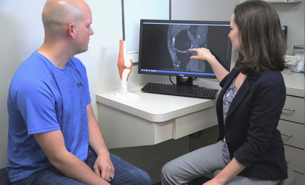 Specialist showing the results of a diagnostic test to a patient