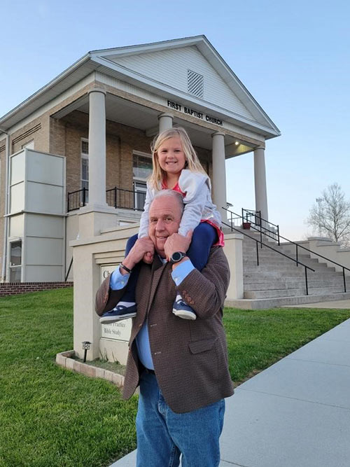 Pastor Steve Collins with his granddaughter