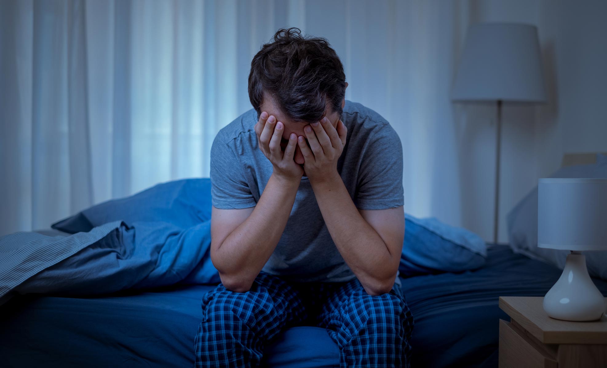Tired person trying to get out of bed