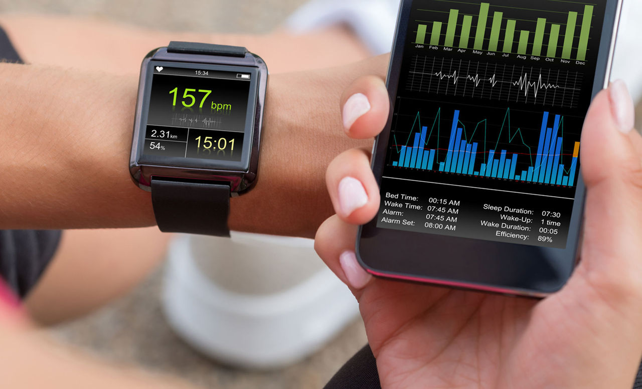 Person using a smart watch and phone with health interface