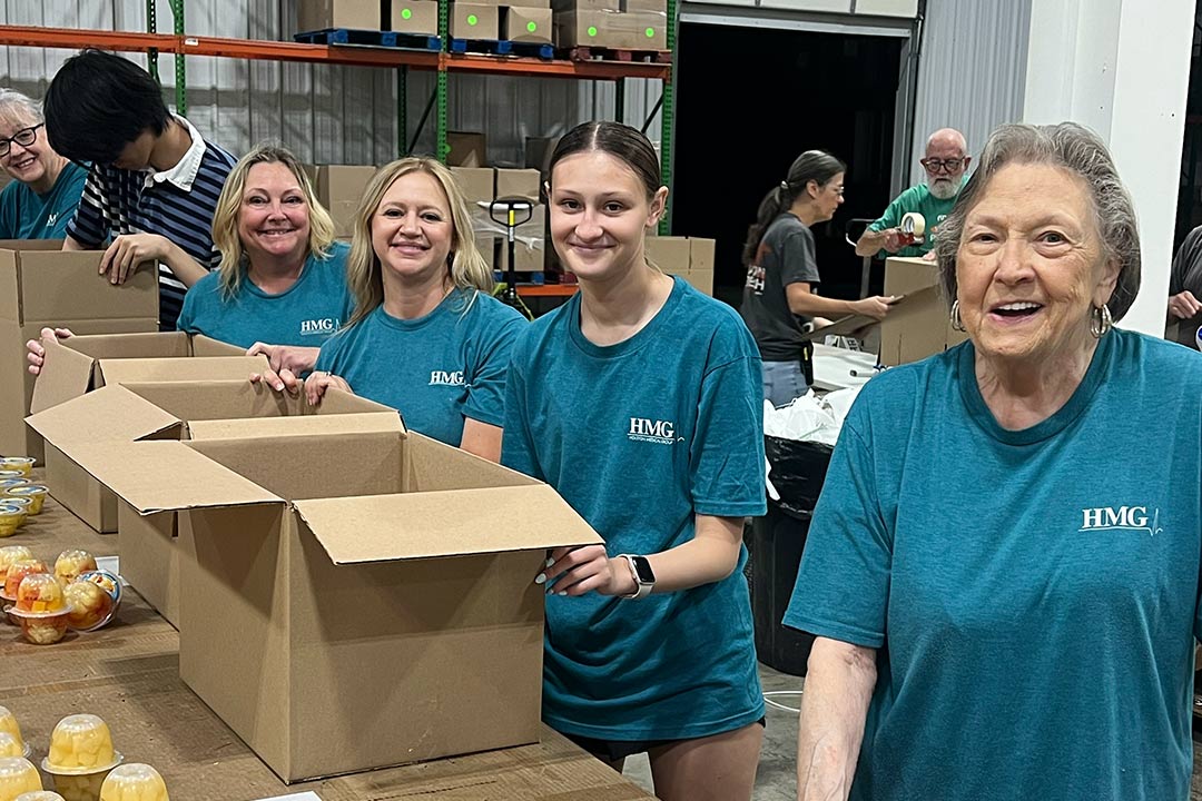 HMG employees working at a food drive for community service
