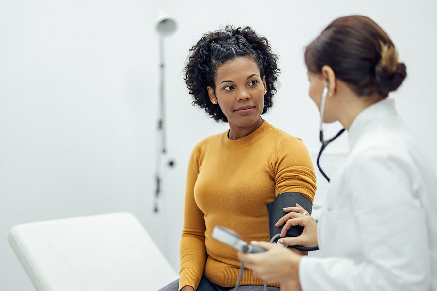 Doctor talking with a patient during an exam