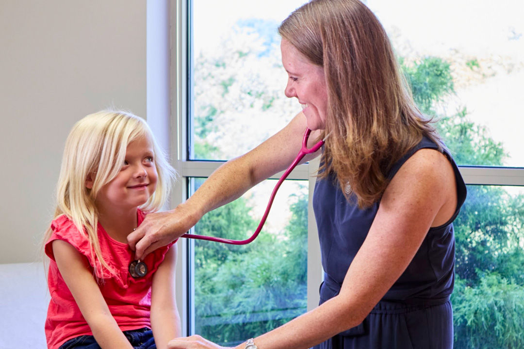 Pediatric patient with pediatrician during an exam