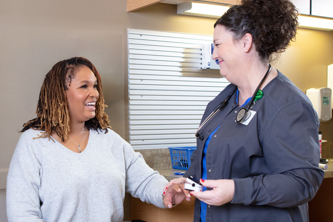 Patient talking with nurse during an urgent care visit