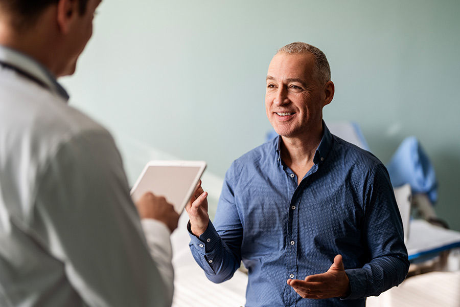 Doctor talking to patient during an exam